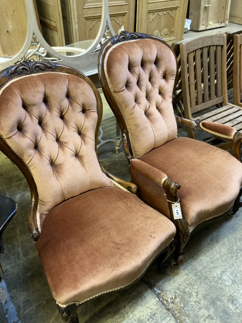 A pair of Victorian walnut spoon back button back chairs (one with arms)